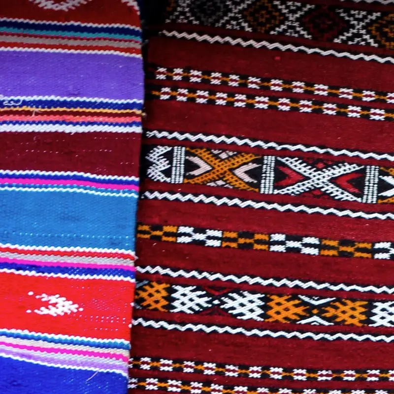 Woven textiles with red and striped Berber patterns