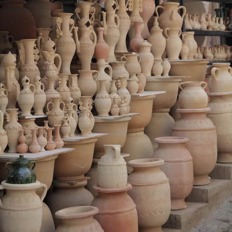 Unfired clay jars and jugs lined up